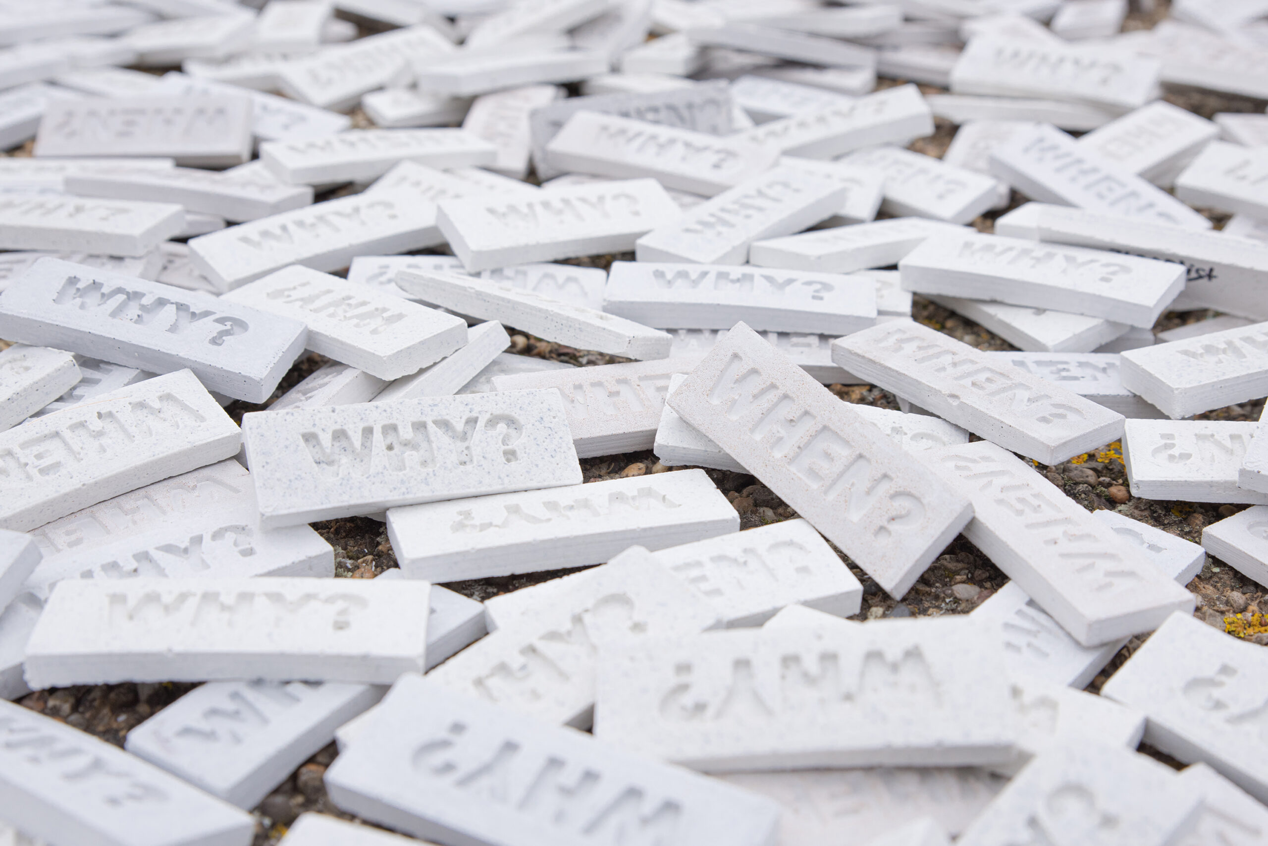 Concrete tiles embossed with “WHEN?” and “WHY?” in preparation for 742’s project I Have Only Two Questions.